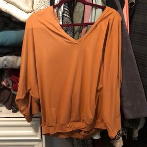 Off the shoulder orange fall shirt.